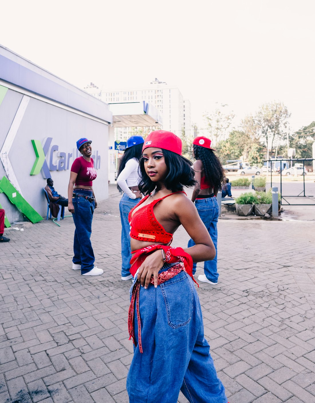 A dancer posing in a red cap